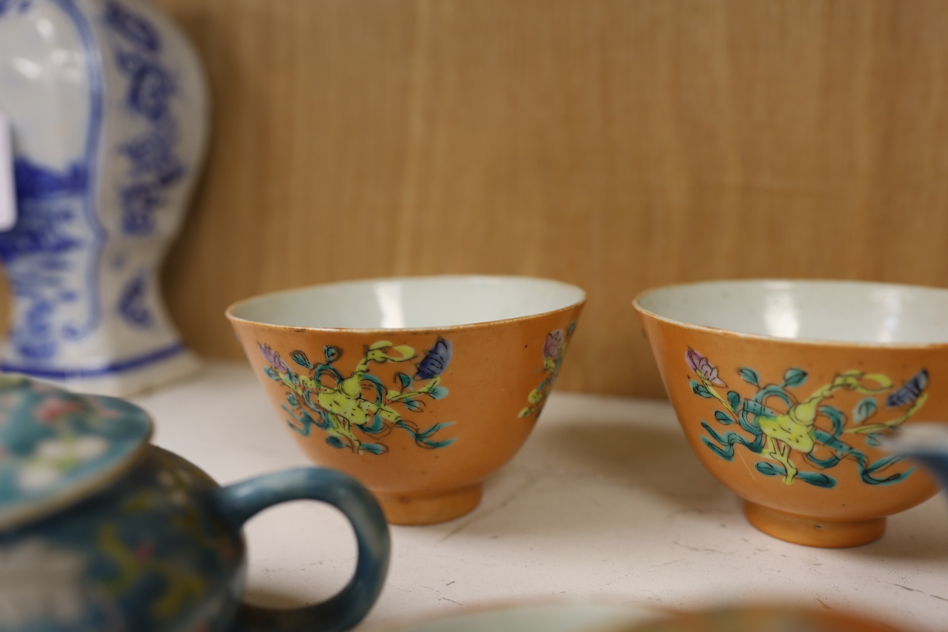 Two Chinese blue ground teapots, Tongzhi mark, and a pair of orange ground bowls and covers, teapots 15cm wide. Condition - fair